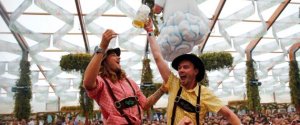 File picture shows visitors holding up the first mug of beer after the tapping of the first barrel during the opening ceremony for 181st Oktoberfest in Munich